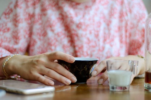 Person Touching Ceramic Mug