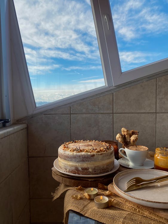 Free Cake on a Table by the Window  Stock Photo