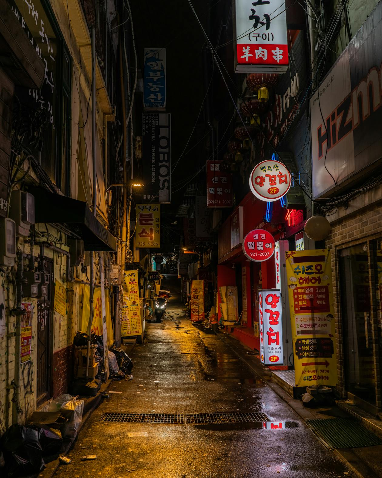 Colorful Korean street market at night with neon signs and food stalls