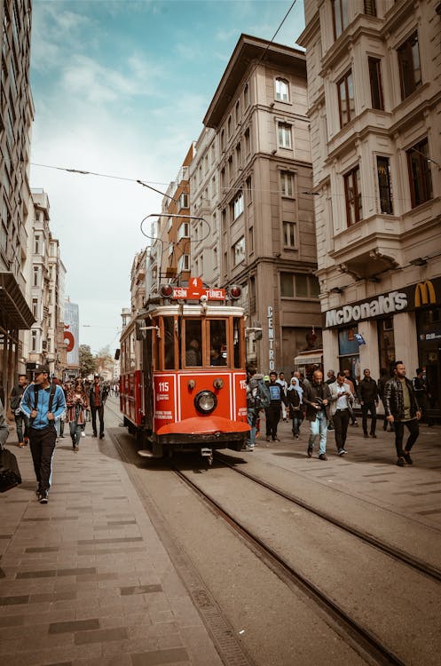 Red Train Between People