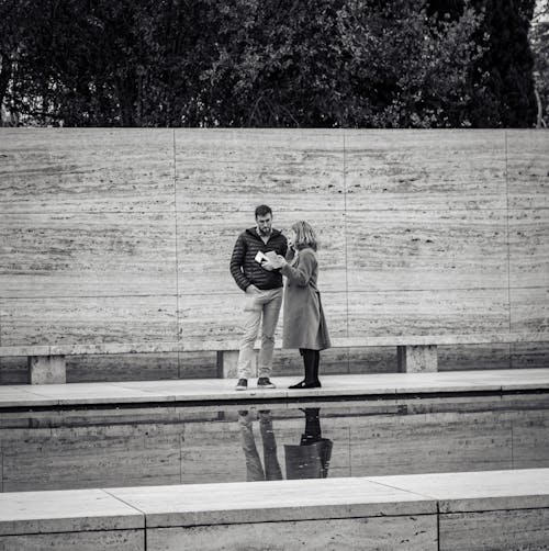 A couple standing in front of a fountain