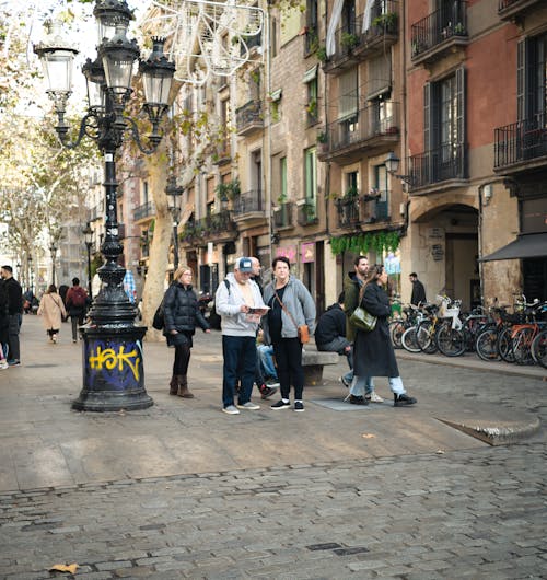 A group of people walking down a street in a city