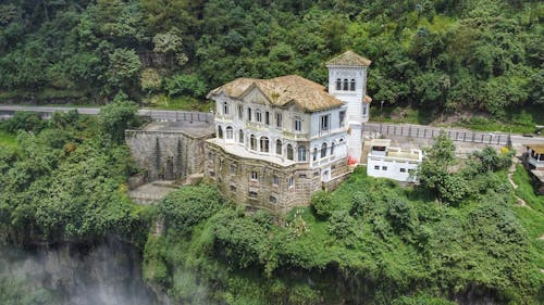 An aerial view of a house on top of a cliff