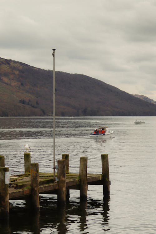 A boat is docked at a pier on a lake