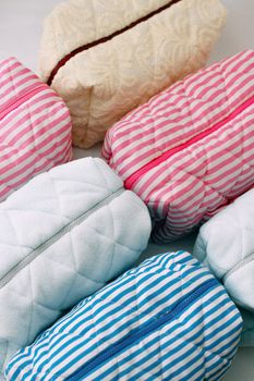 A collection of colorful quilted pillows arranged in a vibrant pattern.