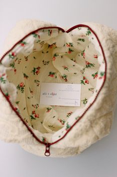 Cozy makeup bag with floral lining, featuring a secure zipper and soft fabric.
