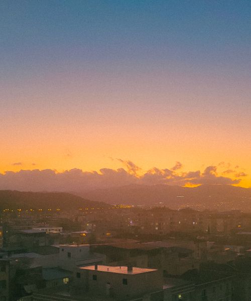 Free Stunning sunset over a town skyline captured from above, radiating warm hues. Stock Photo