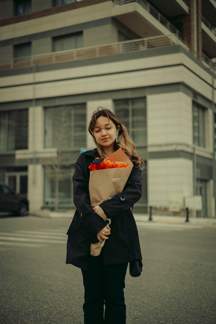 Woman Holding Bouquet Wrapped In Paper