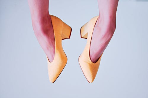 Woman With Pair of Yellow Leather Heeled Shoes