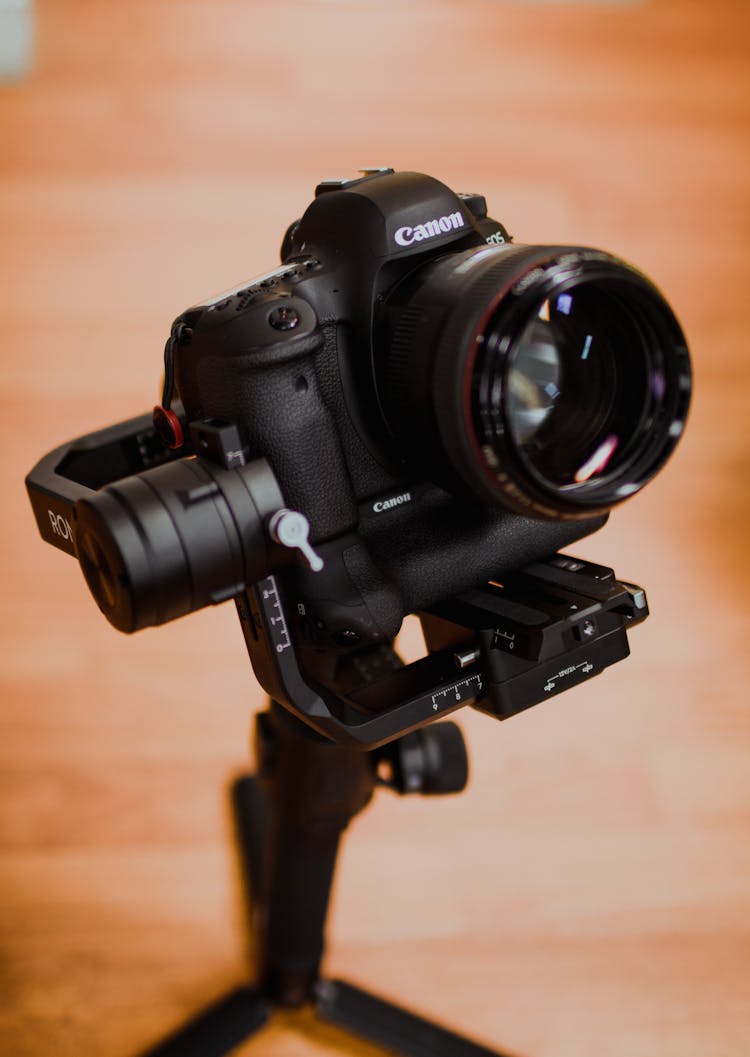 Black Nikon Dslr Camera On Brown Wooden Table