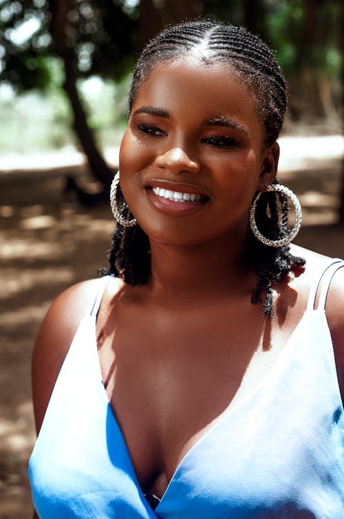 A woman with large hoop earrings and a smile