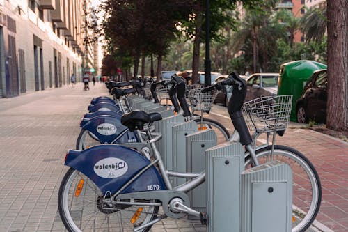 A row of bicycles parked on the side of the road