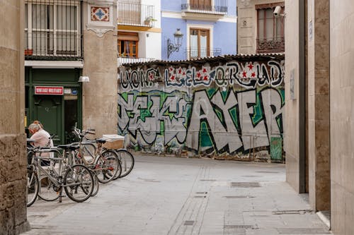 A street with graffiti on it and some bikes