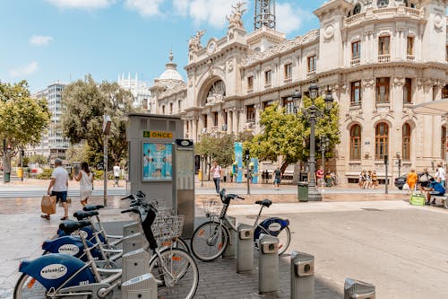 A city street with bicycles parked in front of a building