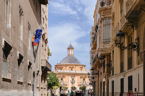 A street with buildings and a church in the background