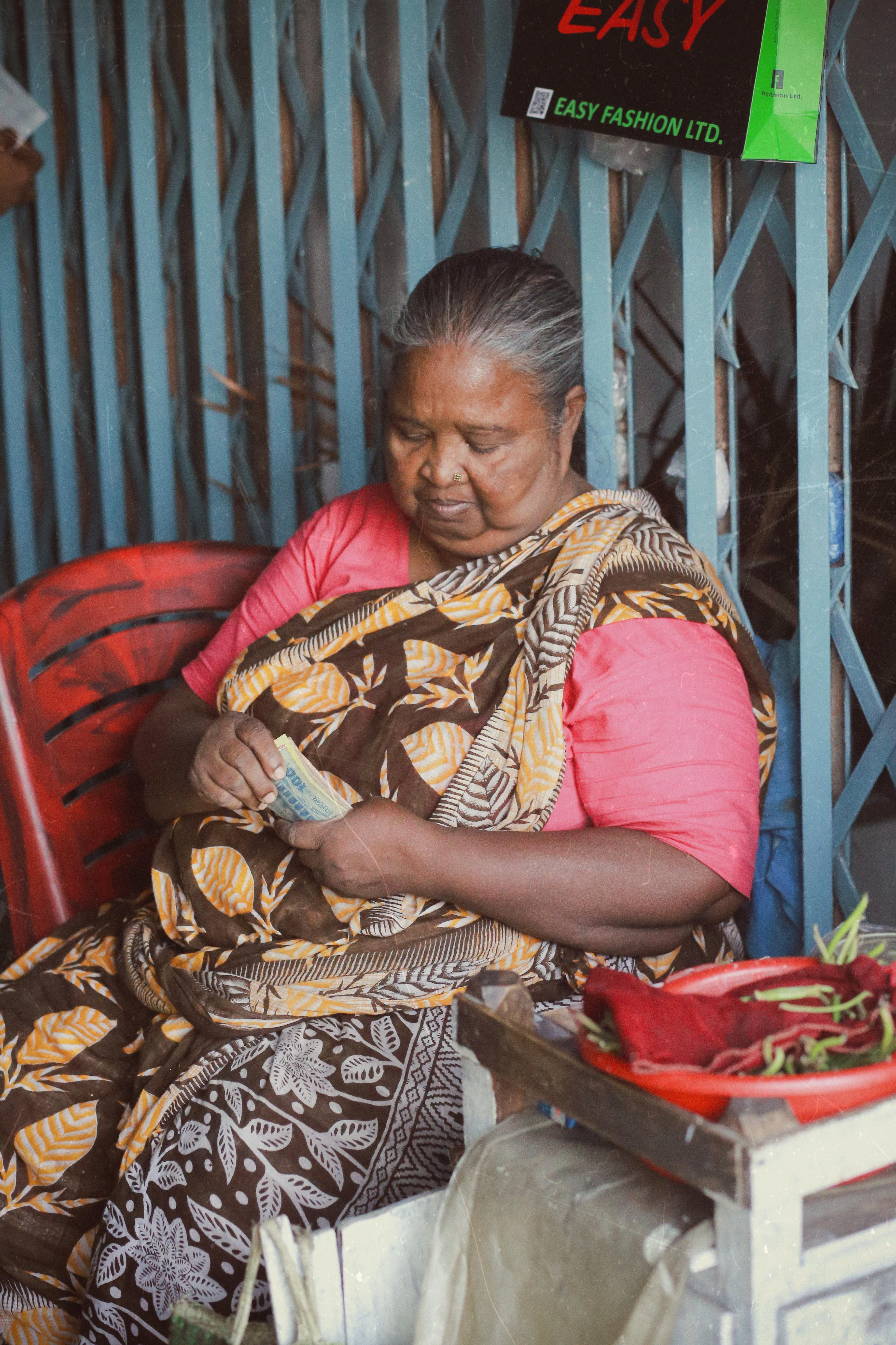 vendor at a market stall counting her takings