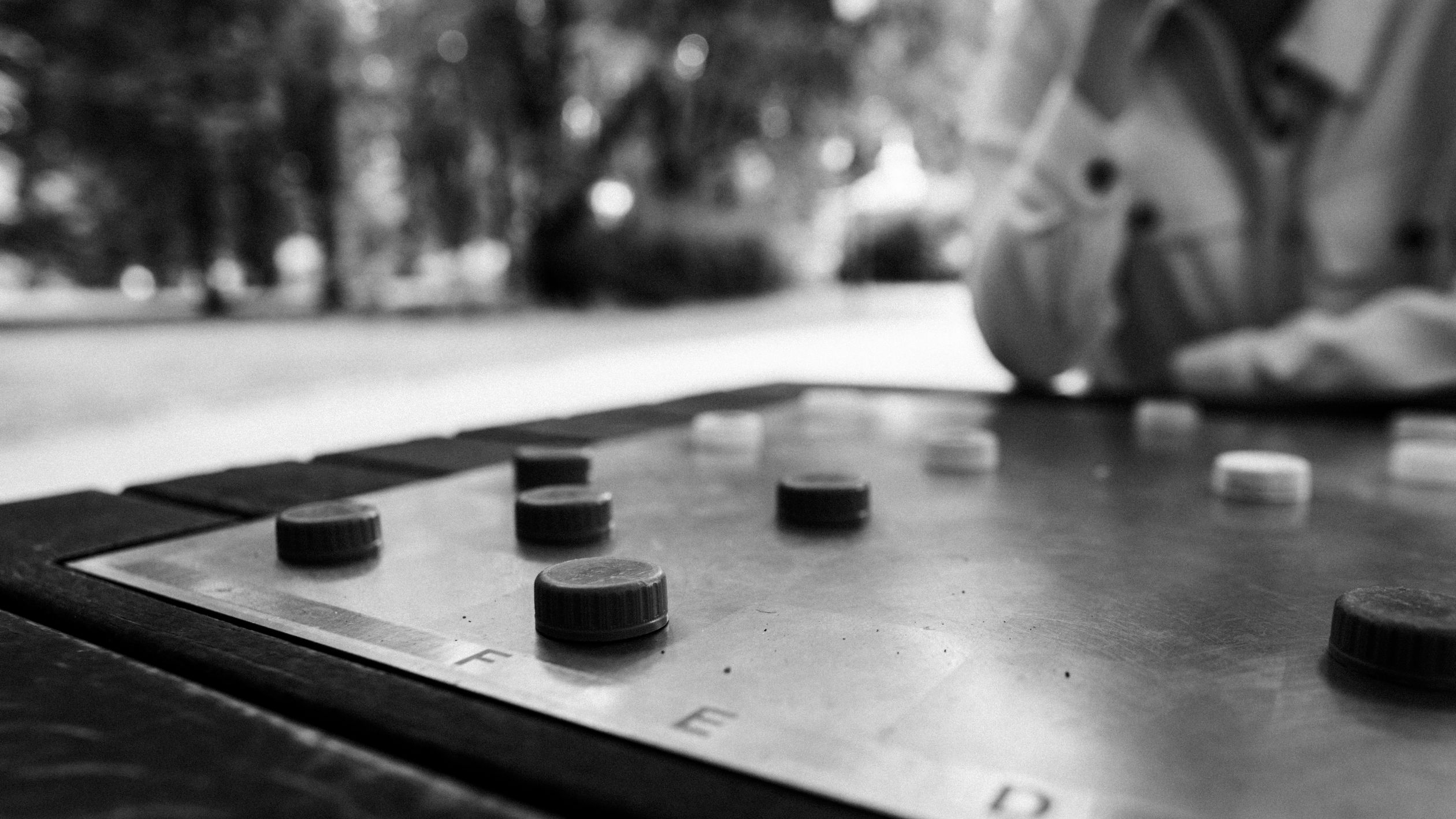 Playing Checkers on a Park Chessboard with Bottle Caps · Free Stock Photo