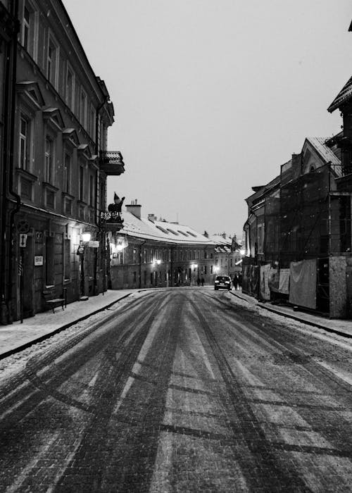 A black and white photo of a snowy street