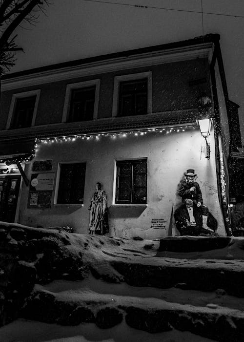 A black and white photo of a statue in the snow