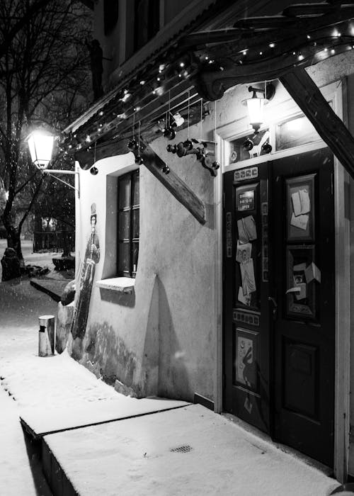 A black and white photo of a snowy street