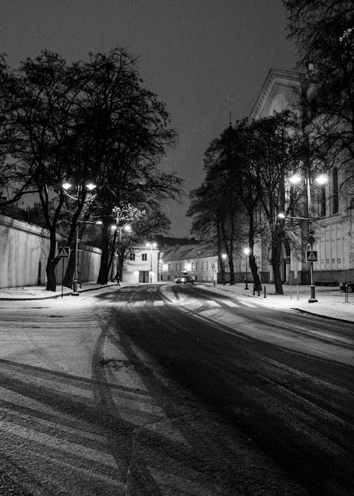 Black and white photo of a snowy street