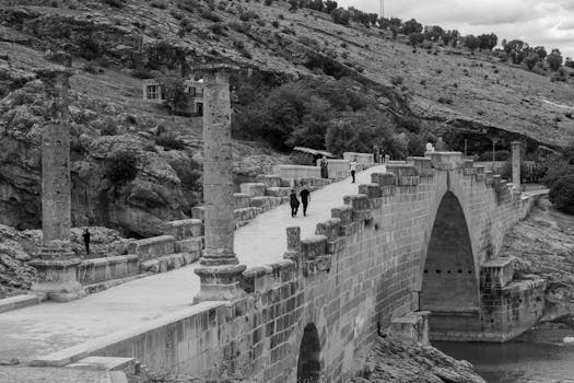 Black and white photo of the ancient Cendere Bridge in Turkey, a Roman architectural marvel.