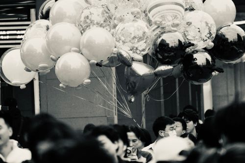 Free A bustling urban scene in black and white featuring a crowd with decorative balloons in Xi An Shi, China. Stock Photo