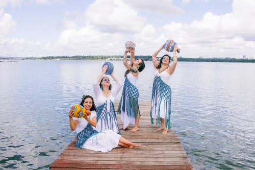 Free Four women in traditional dress pose on a dock Stock Photo