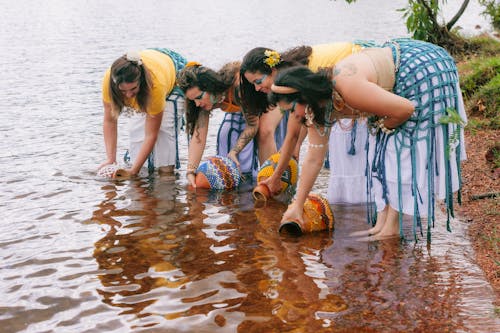 Free A group of women in traditional clothing standing in the water Stock Photo