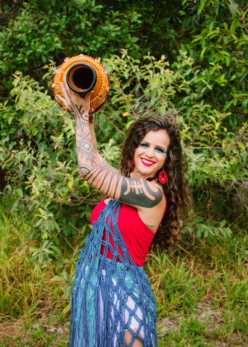 A woman in a dress holding a large pot