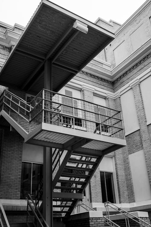 A black and white photo of stairs and a building