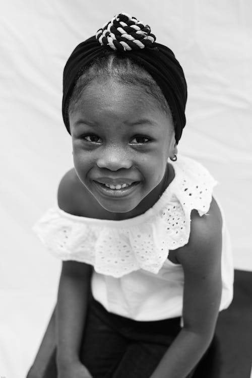 Black and white photo of a little girl smiling