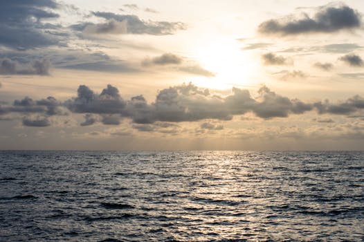 Peaceful sunrise over the ocean in Cartagena, Colombia, with beautiful cloud formations.