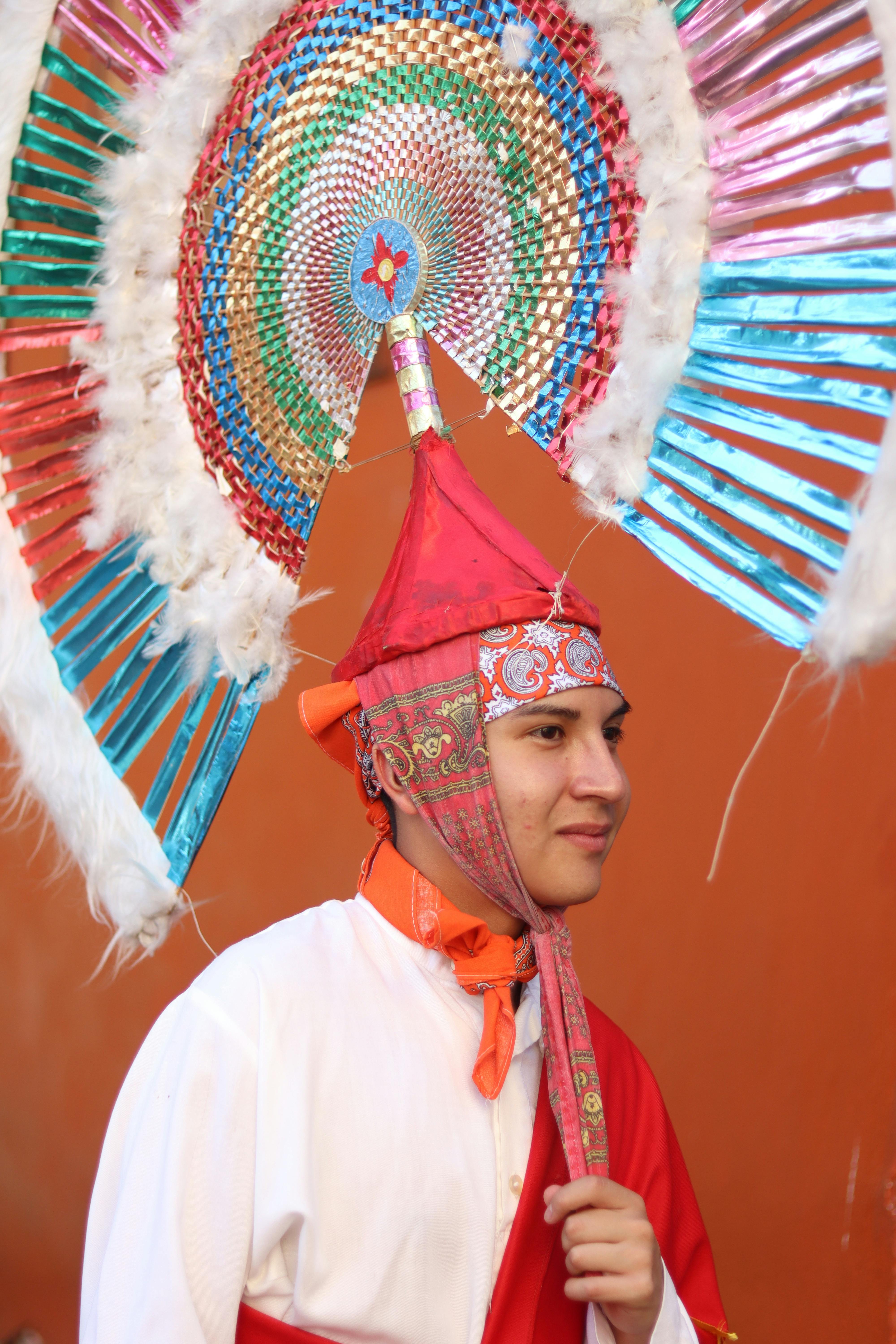 Portrait of a performer in vibrant traditional costume with intricate headpiece.