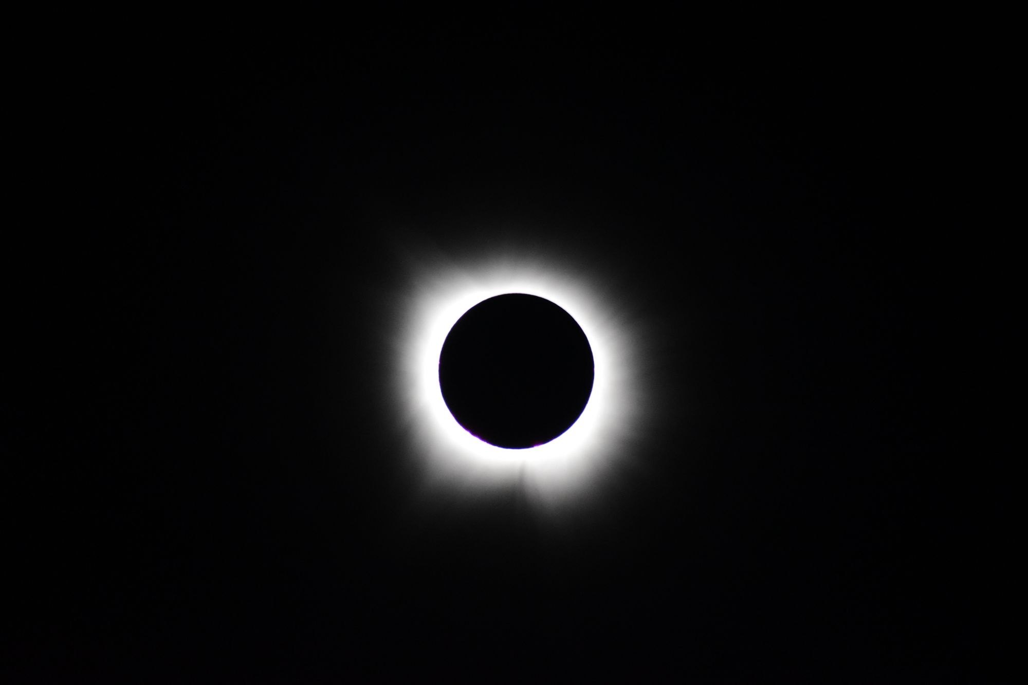Stunning image of total solar eclipse showing the sun's corona against a dark sky.