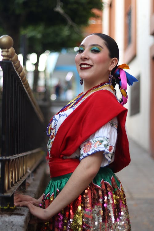 A woman in a mexican costume posing for a picture