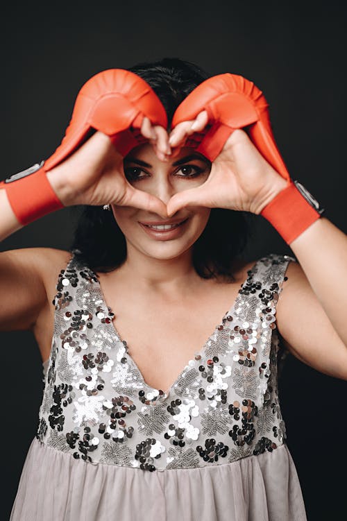 A woman making a heart shape with her hands