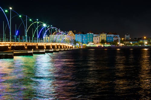 Assorted-color Buildings Near Body of Water at Night