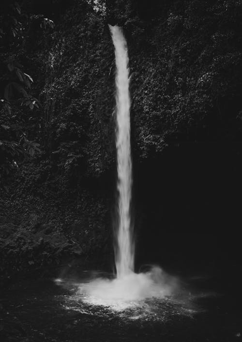 A black and white photo of a waterfall