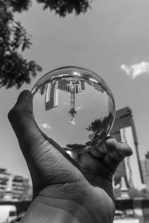 Free A person holding a glass ball in their hand Stock Photo