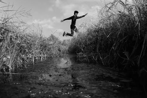 black and frame of men jumping 