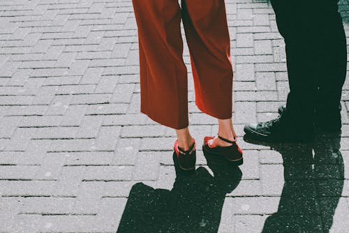 Two Person Standing on Brick Pavement