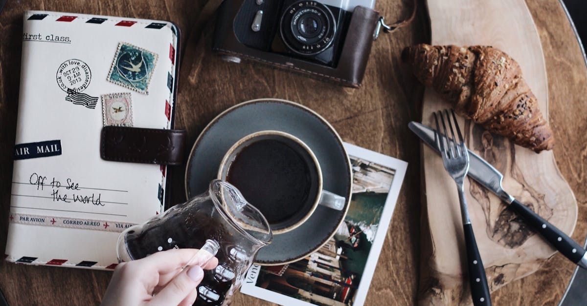 Baked Bread on Brown Wooden Surface Beside Grey Point-and-shoot Camera on Table