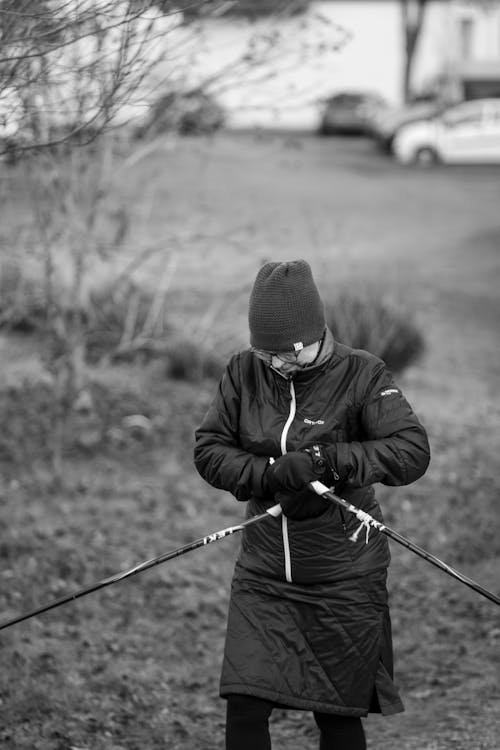 A woman in black and white holding ski poles