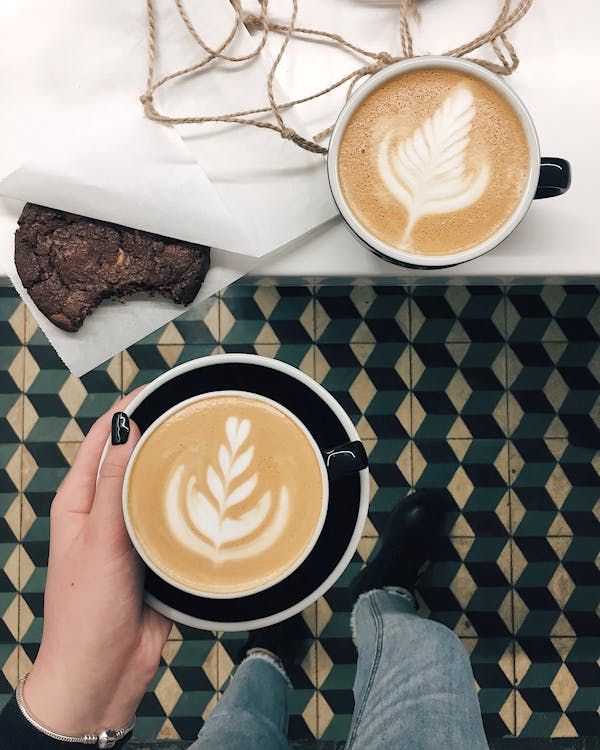 Free Two Cups of Cappuccinos With Chocolate Cookie on Table Stock Photo