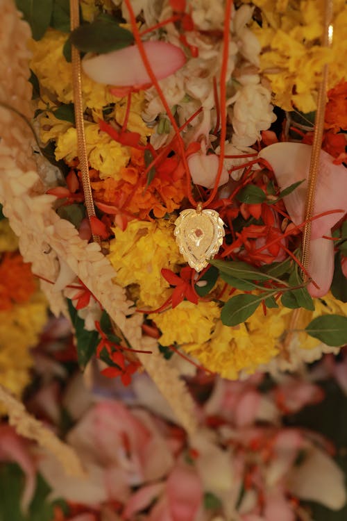 A gold heart is placed in a flower arrangement