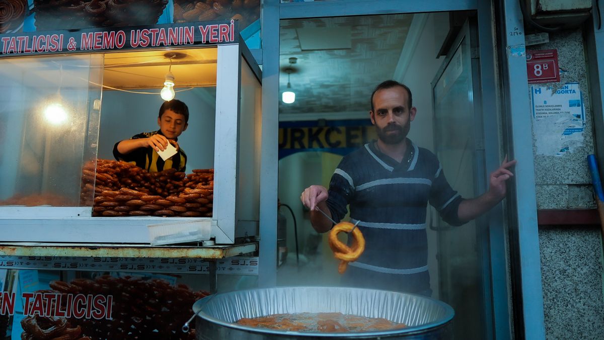 Father and son at a food stand in Diyarbakır, Türkiye, preparing and selling sweet lokum.