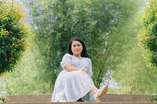 Woman Sitting in White Dress