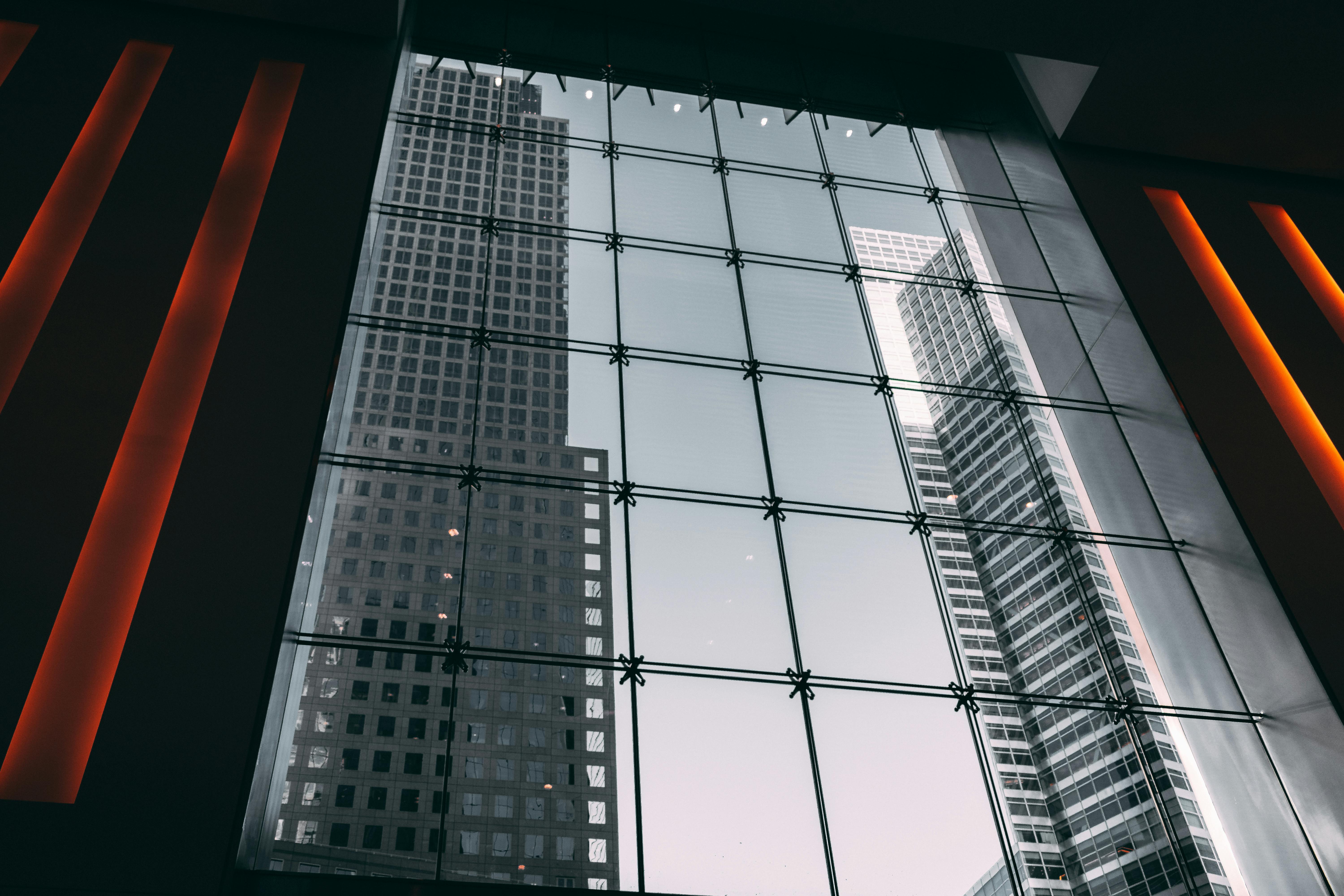 透过大型玻璃中庭的几何设计，欣赏现代摩天大楼