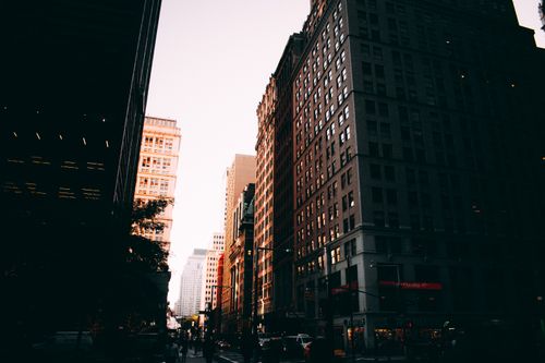 Free Cityscape photo capturing downtown New York City at sunset with tall buildings and urban lights. Stock Photo